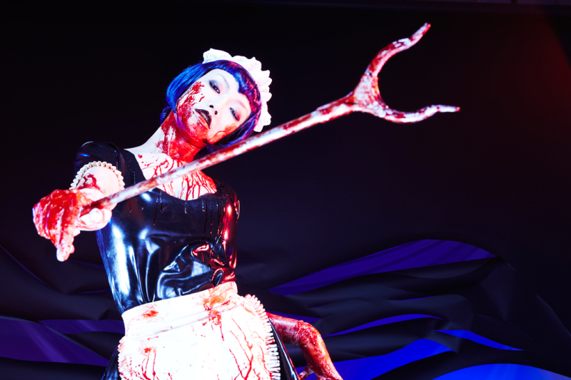 Illustration for article titled Controversial Game Brought to Life With Tight Rubber, a Nice Lady and Fake Blood